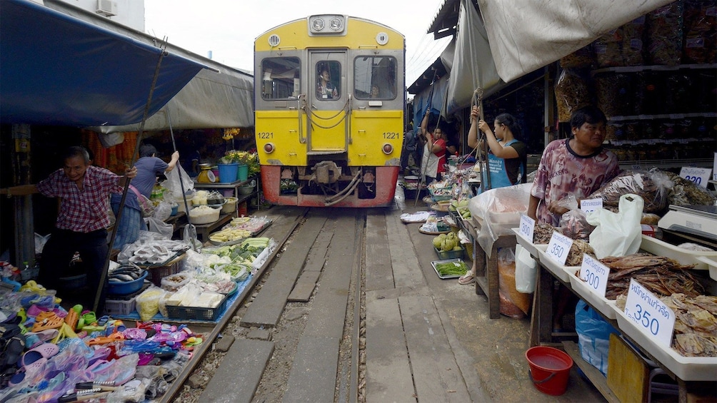People work at  Maeklong Railway Market in Thailand