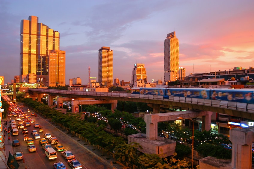 The sun sets on office buidlings in Bangkok