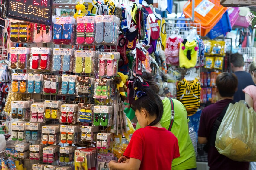 Tourists look at socks at Bangkok market