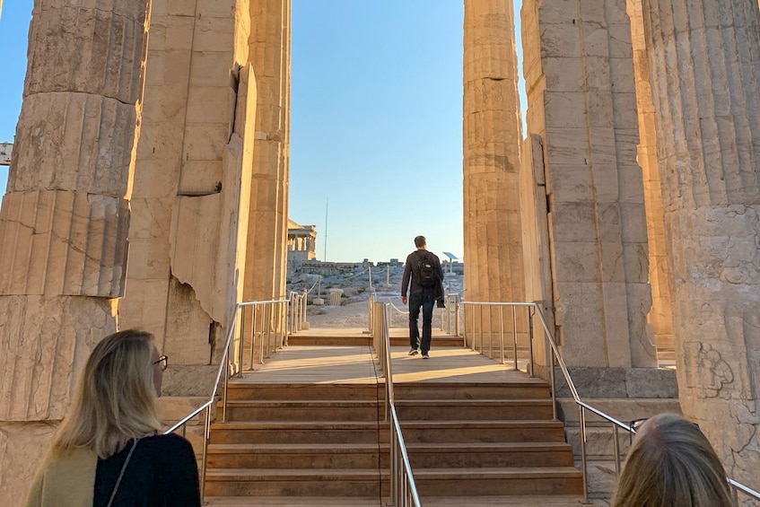 Tour group walks through an Ancient Greek temple