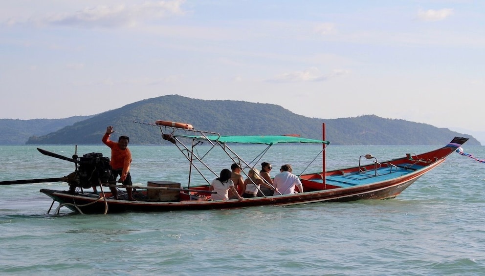 Small group on longboat in Thailand