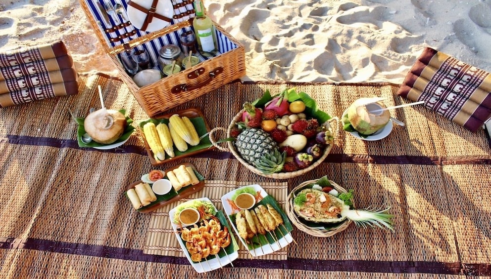 Gourmet picnic on bamboo mat on Thailand beach