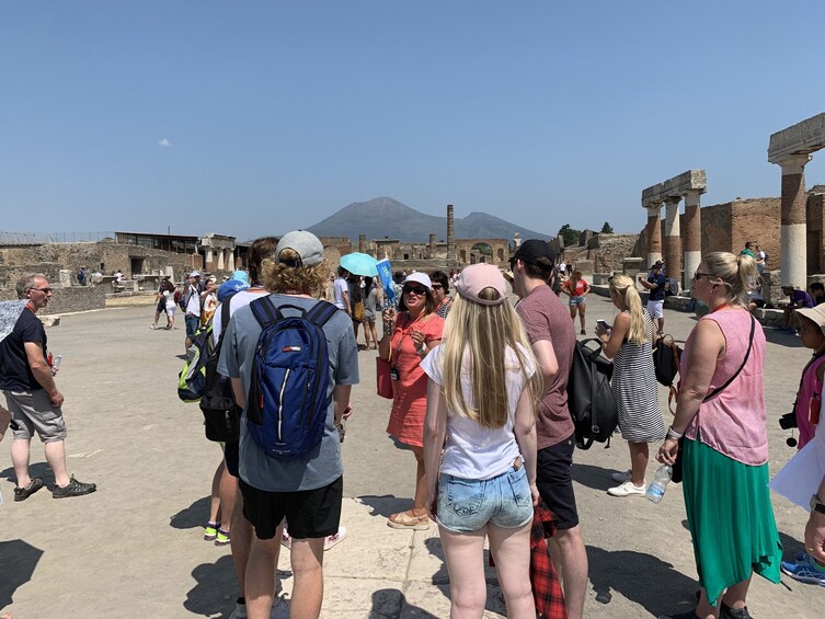Tourists walk around Pompeii ruins