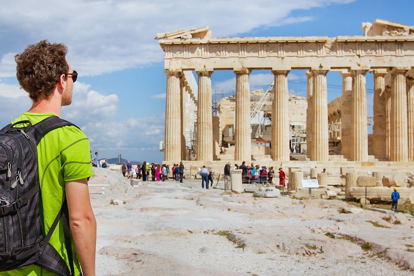Person looks on at tourists at the Acropolis