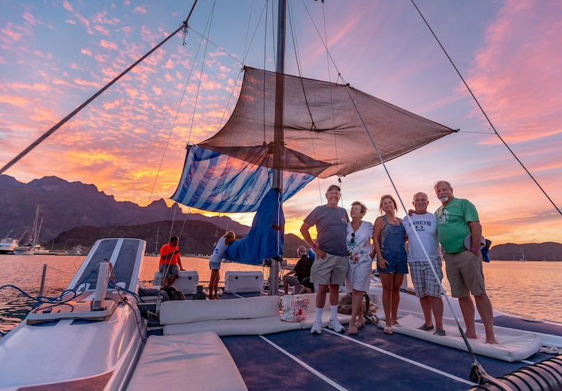 Friends on catamaran deck at sunset in Baja, Mexico
