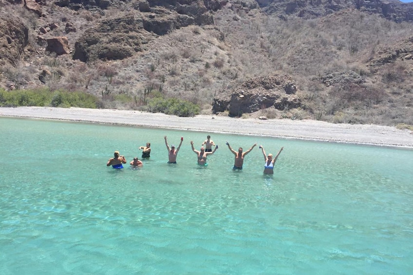 People swim off the coast of Coronado Island near Loreto, Mexico