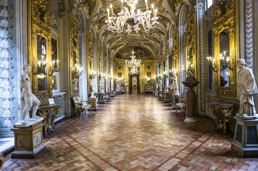 Gallery lined with statues and paintings in the Doria Pamphili Gallery