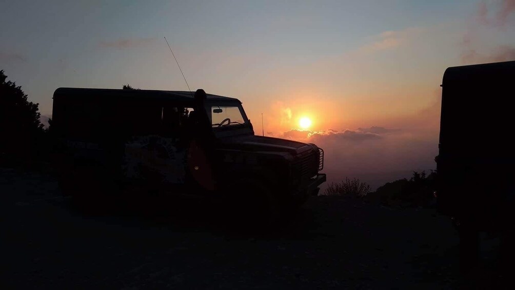 Sun sets behind Jeep parked in Vatolakkos, Greece 