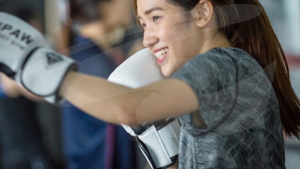 Woman enjoying a Muay Thai Training workout in Bangkok