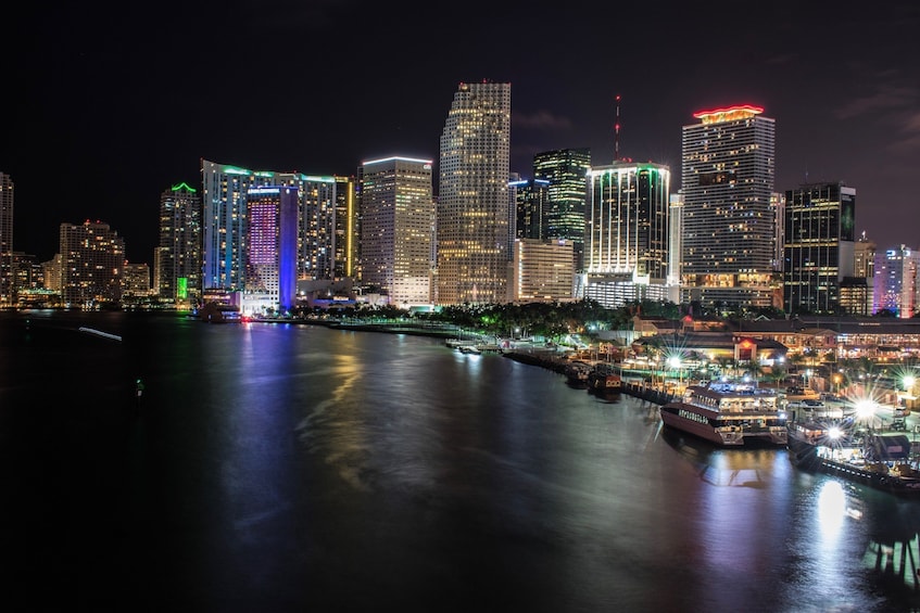 Miami skyline over the water at night