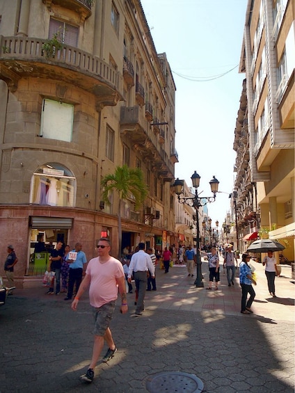 People walk city street in Santo Domingo, Dominican Republic