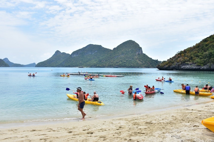 Tourists kayaking and relaxing at the secluded Song Pee Nong Beach on Koh Phalaui