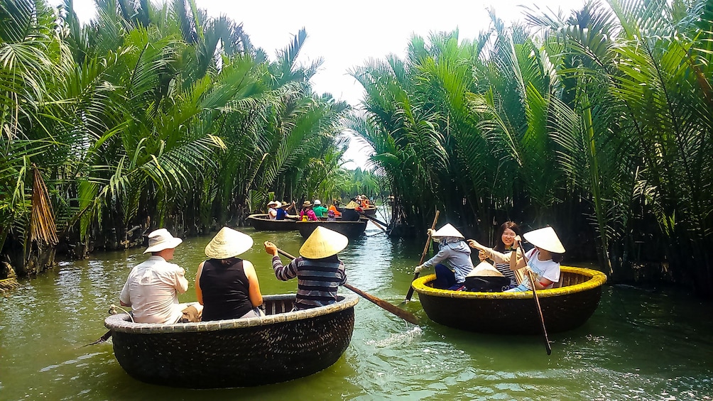 People ride in basket boats in Hoi An's Coconut Village