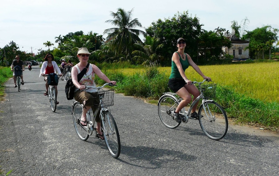 Small group cycle on road in Hoi An, Vietnam