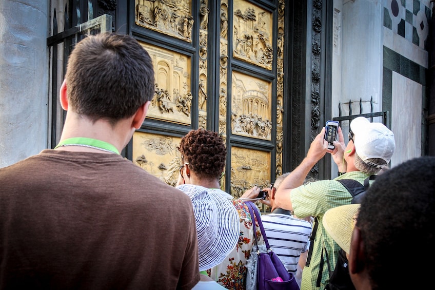 Visitors taking photos of the Cathedral of Santa Maria del Fiore in Florence, Italy 