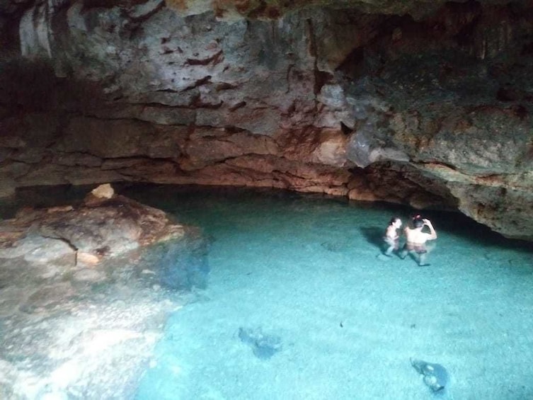 Couple swimming in a cenote in Mexico