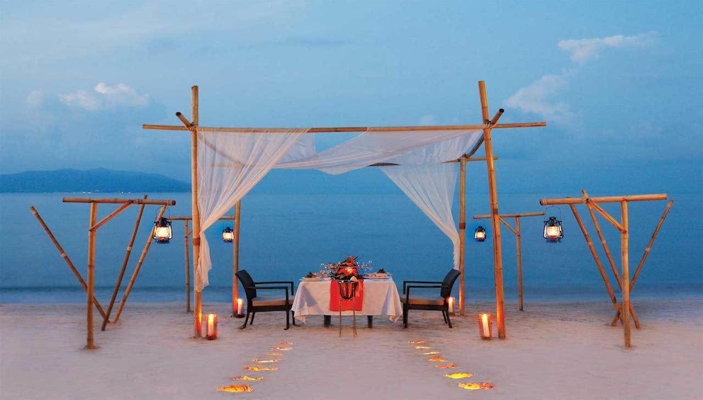Two-person dining table on the beach in Thailand