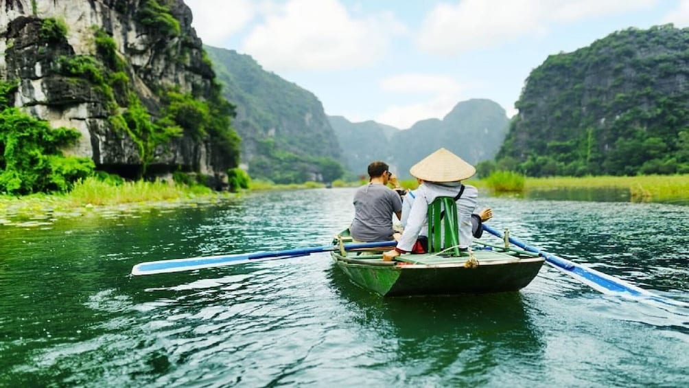 Tourists on small boat in Tam Coc, Vietnam