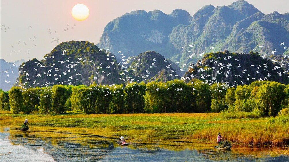 The sun sets over Van Long Wetland Nature Reserve