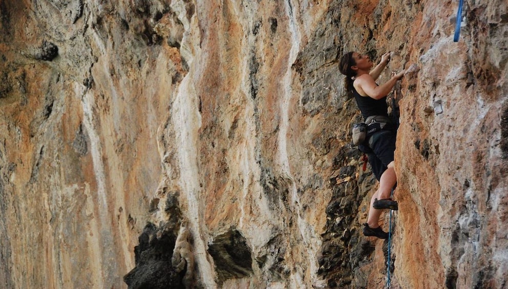 Woman rock climbing in Krabi, Thailand