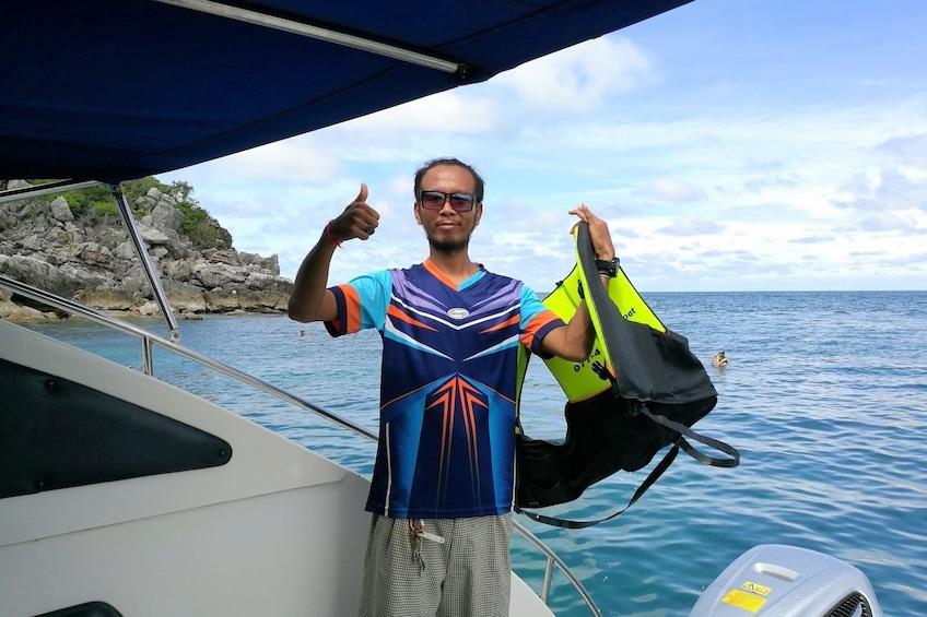 Man gives a thumbs up on speedboat in the Gulf of Thailand