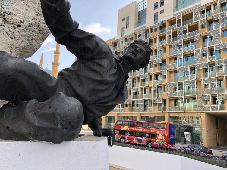 Statue in Beirut with a view of the City Sightseeing bus in the background 