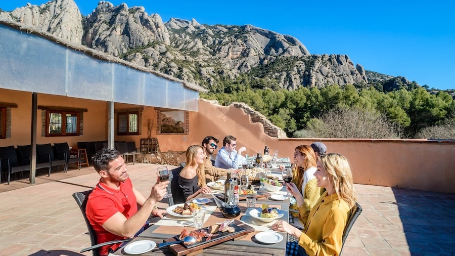 Group enjoying a lunch at a family run Farmhouse, under the mountain in Barcelona