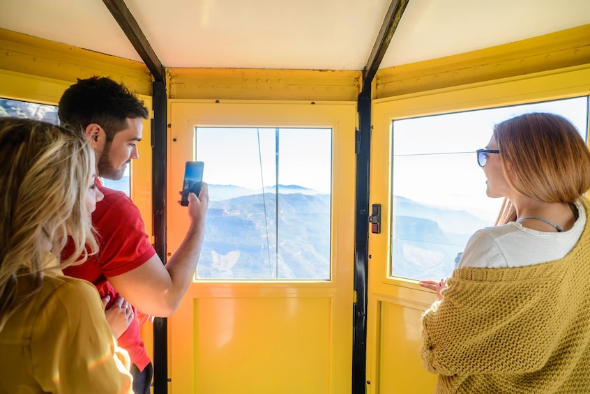 Guests aboard the Aeri Cable Car in Barcelona 