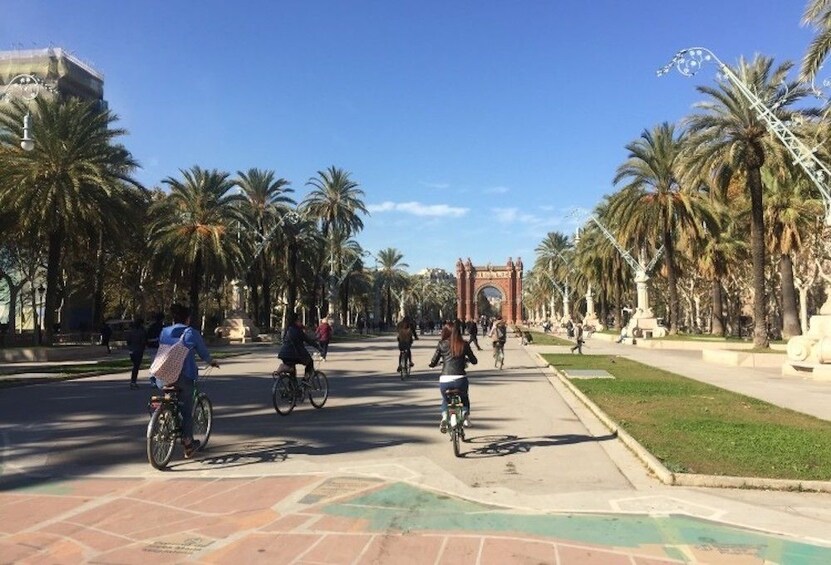 Tourists bike towards Arco de Triunfo in Barcelona, Spain