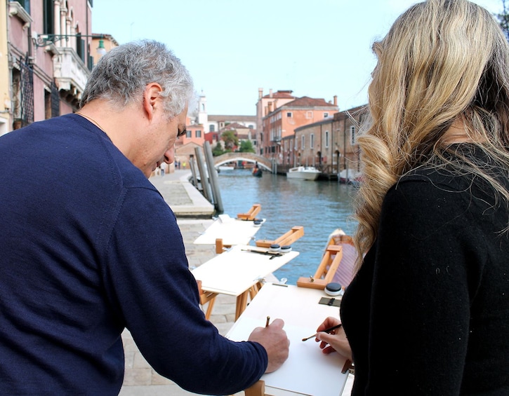 Two people doing watercolors in Venice