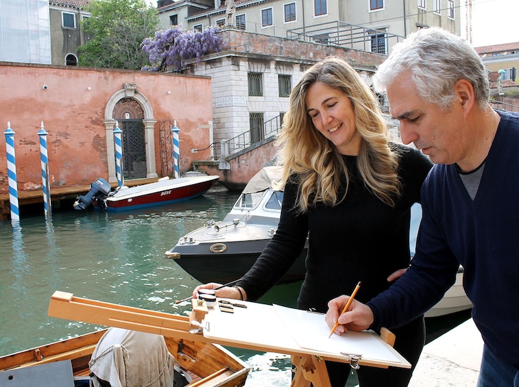 Two people doing watercolors in Venice