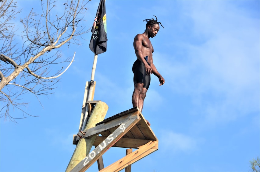 Man getting ready to cliff dive at Rick's Cafe 