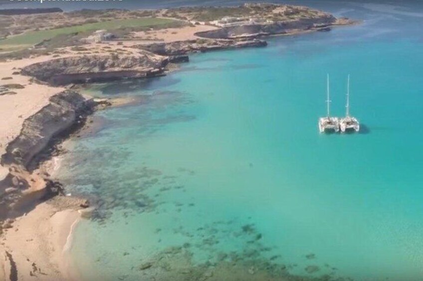 Two of our catamarans anchored at Cala Conta