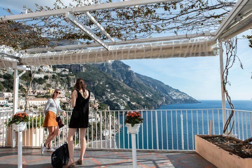 Travelers stop for a photo op in the town of Positano on the Amalfi coast.