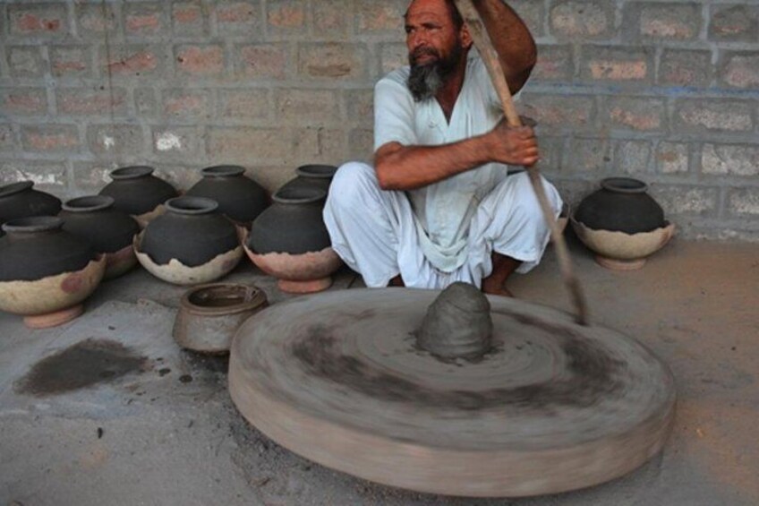 Artist making clay pot