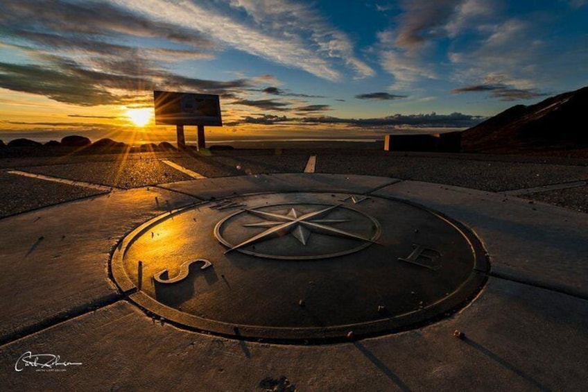 Compass and sunset at Glen Alps overlook in summer.