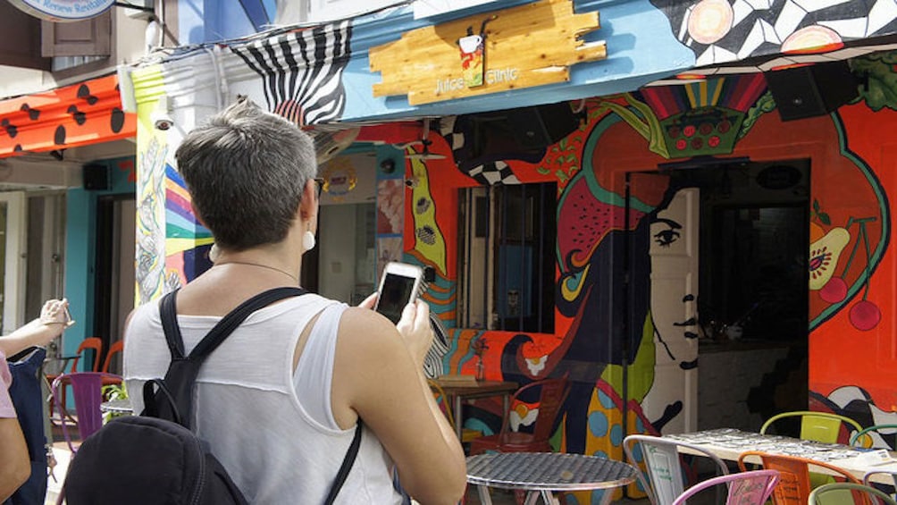 Show item 5 of 10. Brightly painted walls on the side of a juice shop in Singapore
