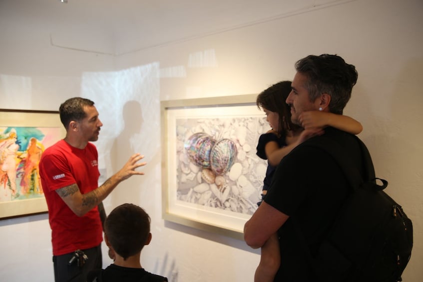 Show item 4 of 8. Family with tour guide looking at art in California