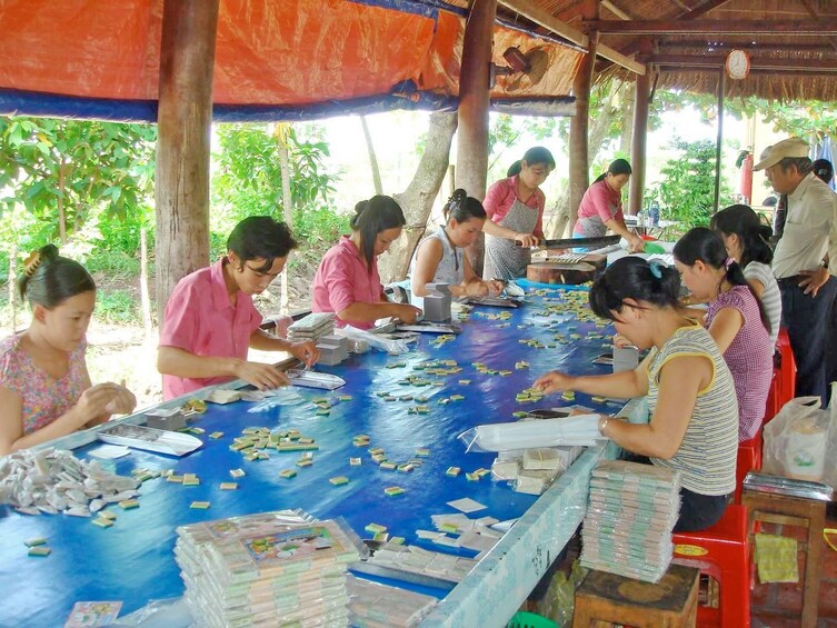 Locals making coconut candy in My Tho, Vietnam