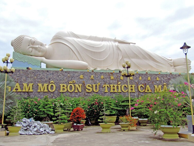 Giant White Buddha sleeping at Vinh Trang Temple in My Tho, Vietnam.
