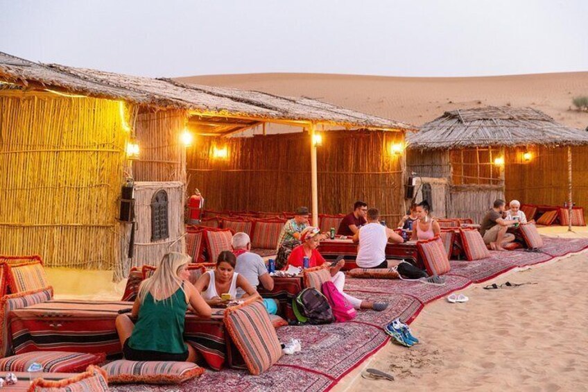 Travelers relax at a desert camp near Dubai.