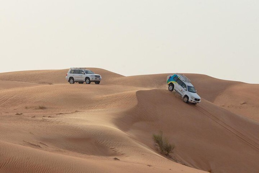 Vehicles travel the “dune road” in the desert near Dubai.