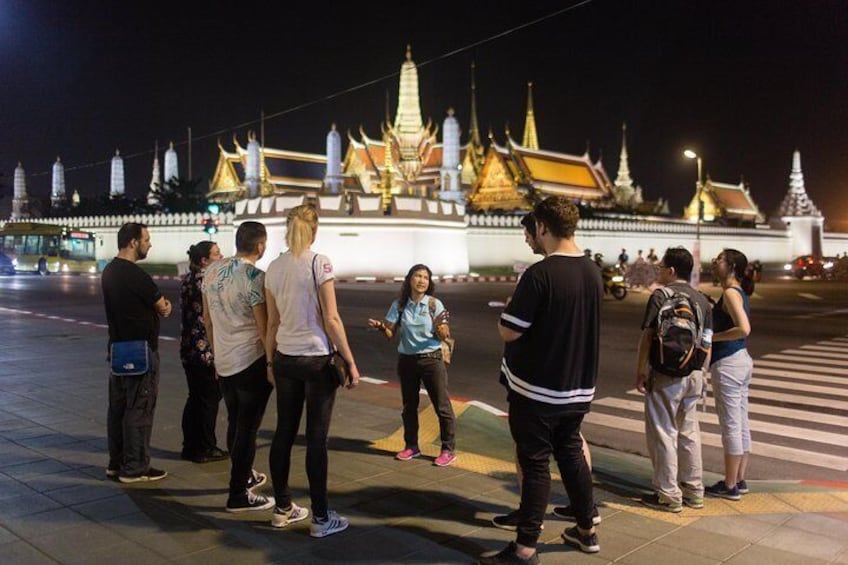 Guide explains features of major Bangkok landmarks like the Grand Palace illuminated at night.