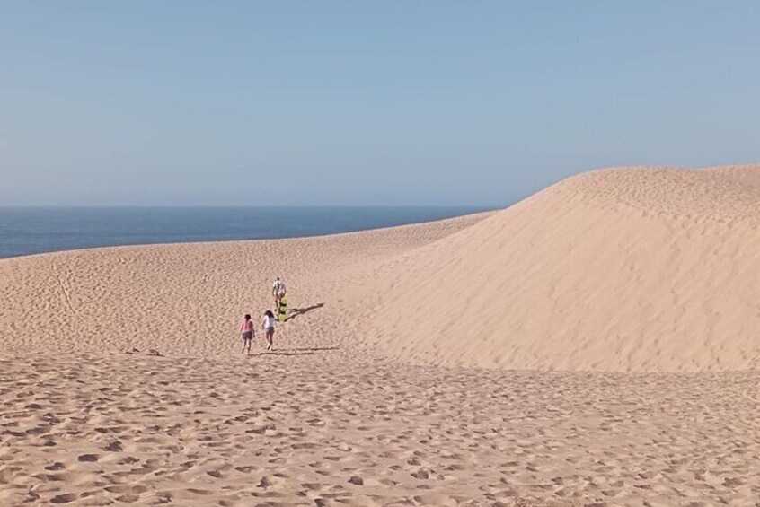 Experience the sandboarding and painted village half day