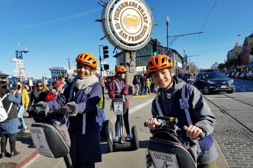 Cruising past the Fisherman's Wharf sign and fishing harbors