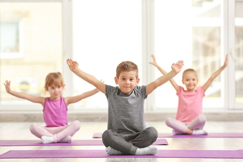 Kids yoga lessons by the water at Dolphin Wellness