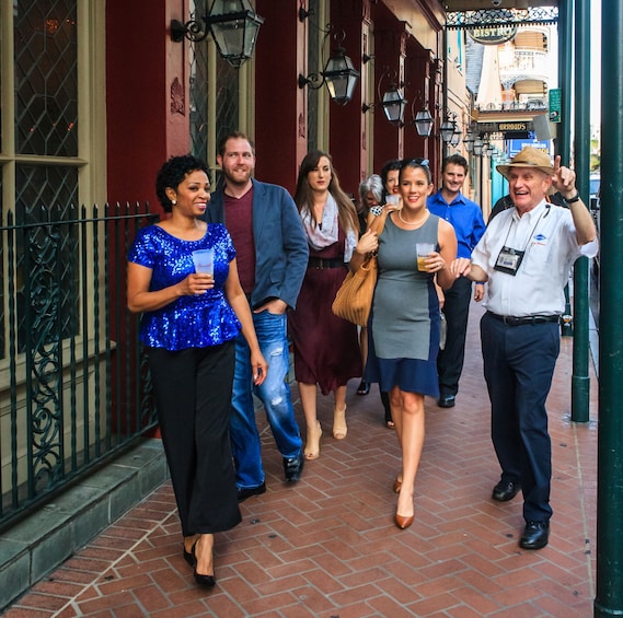 Tour group walking with cocktails in New Orleans