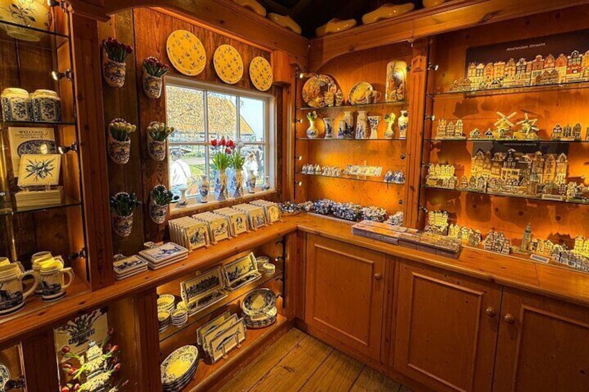 Discover the Delft Blue pottery section at the wooden shoe makery—browse stunning handcrafted pieces and take home a unique Dutch souvenir!