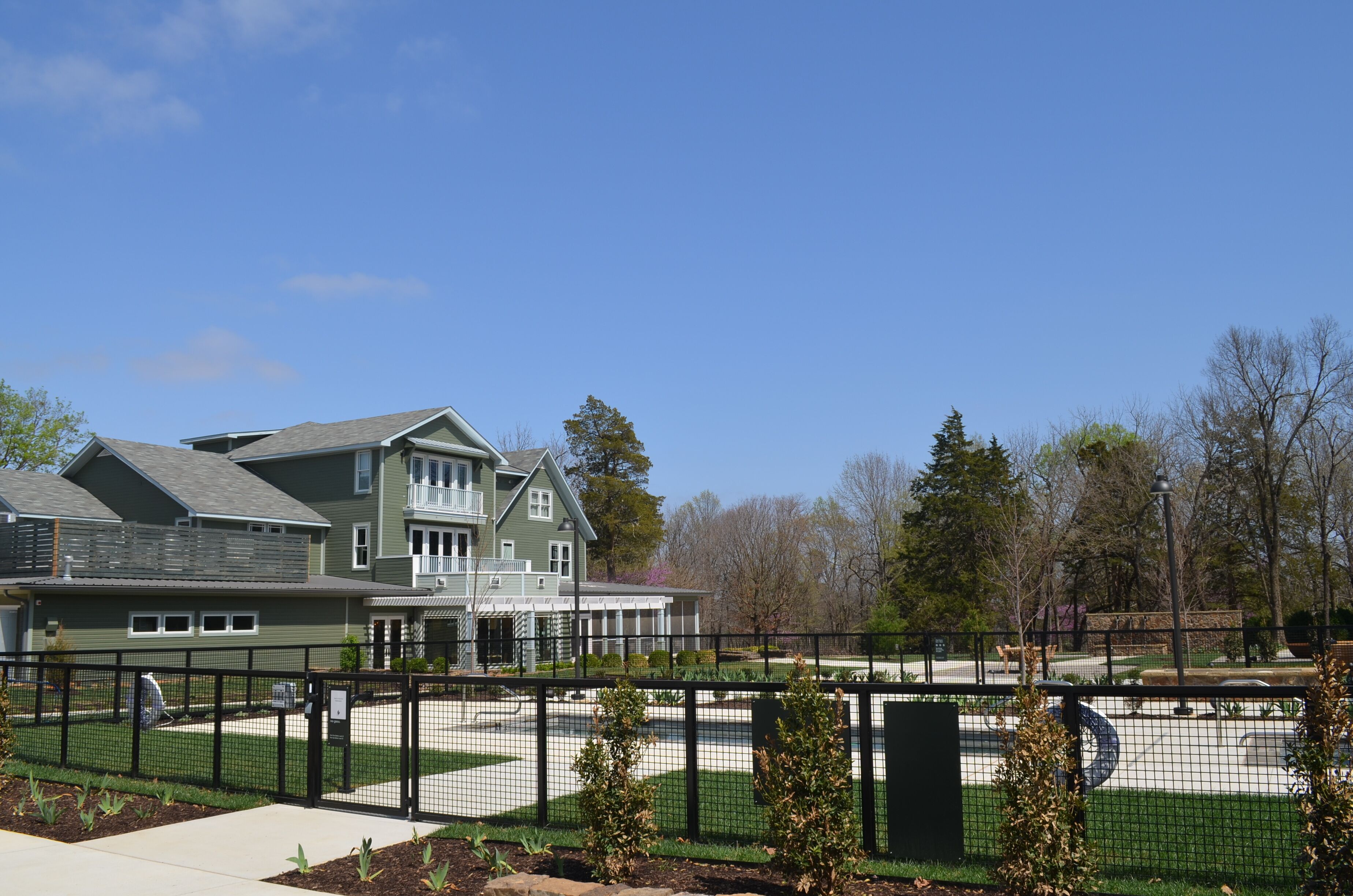 A modern building with a rooftop pool and outdoor seating area.