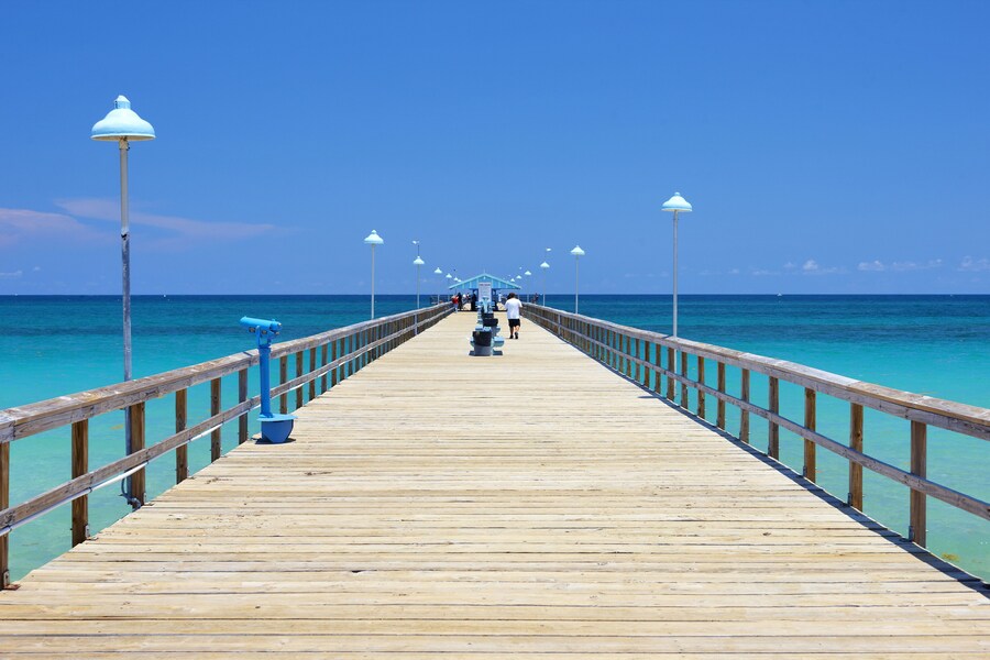 Pier extending into turquoise waters at Lauderdale-by-the-Sea in Fort Lauderdale, Florida.